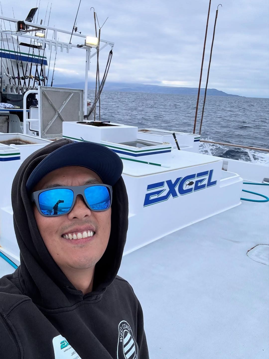 James smiling in front of the Excel long range sportfishing boat
